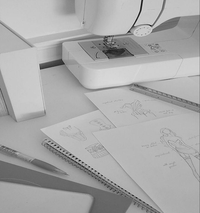 Black and white photo of fashion design and sewing machine