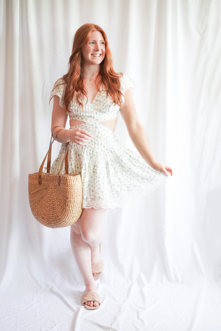 mini dress with lace crochet trim and floral print, flutter sleeves, and a waist side cut out
