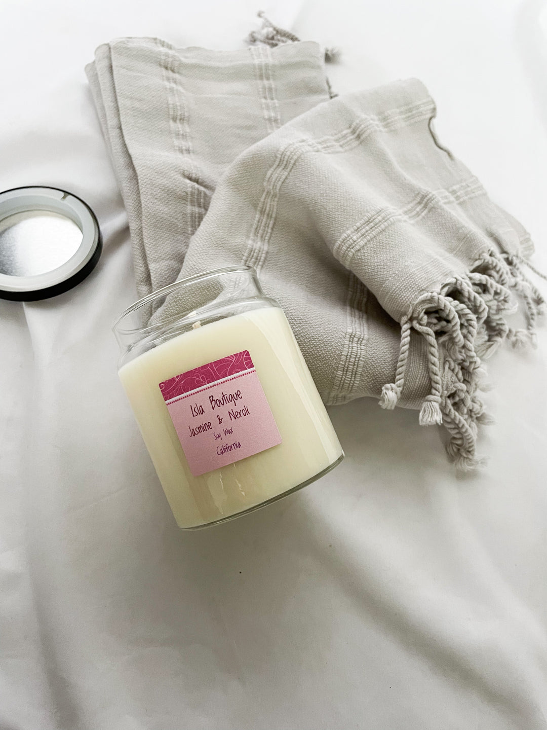 jasmine scented soy candle with grey tea towel