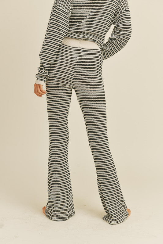 black and white knit pants feature a flare fit and elastic waist band 