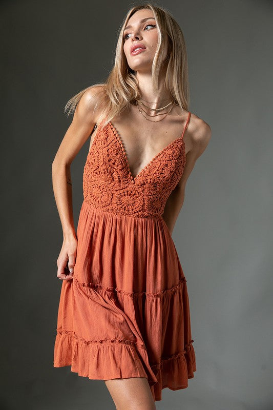 Crochet Dress features a padded crochet bodice with tie up back and adjustable straps
