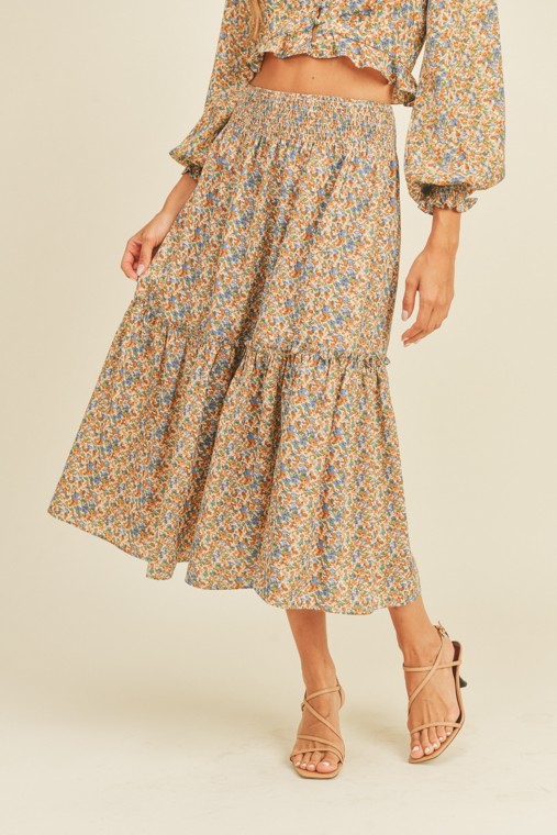 Skirt and top set with a ruffle hem and button front closure on the top, and an elastic waistband and side slit on the skirt.