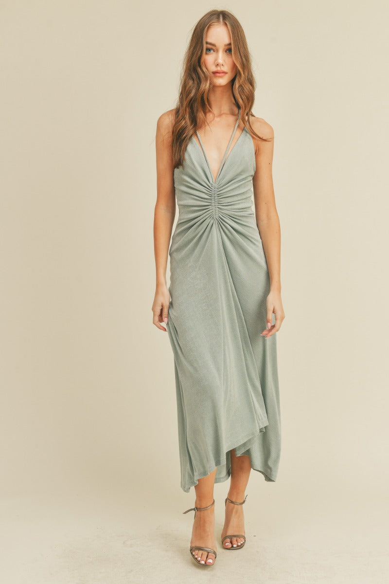 Ruched minty-grey halter dress with slinky fabric, deep v-neck detail, midi length and self tie open back detailing. 