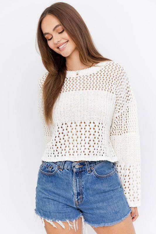 Model is wearing a creamy white crochet sweater. The sweater is a super soft woven knit material. It is almost see through on top and bottom but is extra thick near the chest area and on a part of the sleeve.